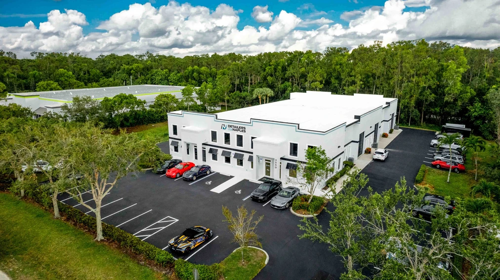 Aerial view of the Detailers of Naples facility with cars parked outside